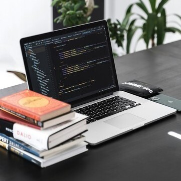 MacBook Pro on black wooden table